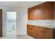 Plenty of storage with wood cabinets and granite counters; laundry room visible at 4989 Clubview E Ct, Bradenton, FL 34203