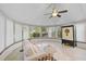 Inviting sunroom with a light sofa, tile floor, an armoire and lots of light from the surrounding windows at 4989 Clubview E Ct, Bradenton, FL 34203
