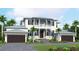 Stunning two-story home featuring a balcony, dark shutters, two-car garage, and lush landscaping at 118 N Warbler Ln, Sarasota, FL 34236