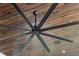 Modern black ceiling fan with wood accent at 11826 River Shores Trl, Parrish, FL 34219