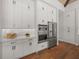 Modern kitchen with stainless steel appliances and white cabinetry at 11826 River Shores Trl, Parrish, FL 34219