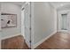Light and airy hallway with white doors and wood floors at 11826 River Shores Trl, Parrish, FL 34219