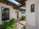 Side entry with pergola, pavers, and lush landscaping at 11826 River Shores Trl, Parrish, FL 34219