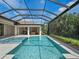 Relaxing pool and spa with a covered patio and lush greenery at 11826 River Shores Trl, Parrish, FL 34219