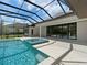 Covered patio with a refreshing pool and spa, ideal for entertaining at 11826 River Shores Trl, Parrish, FL 34219