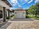 One-car garage with paver driveway and exterior lighting at 11826 River Shores Trl, Parrish, FL 34219