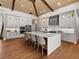 Modern kitchen with white cabinets, stainless steel appliances, and a large island at 11826 River Shores Trl, Parrish, FL 34219