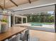 Open dining space features sliding doors leading to a relaxing pool area at 11826 River Shores Trl, Parrish, FL 34219