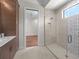 Bathroom with glass shower, built-in bench and a view of bedroom at 11826 River Shores Trl, Parrish, FL 34219