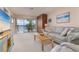 Living room with water views and comfortable seating at 9011 Midnight Pass Rd # 228, Sarasota, FL 34242
