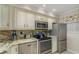Modern kitchen with granite countertops and stainless steel appliances at 9011 Midnight Pass Rd # 228, Sarasota, FL 34242
