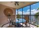 Spacious balcony with water views and comfortable seating area at 9011 Midnight Pass Rd # 228, Sarasota, FL 34242