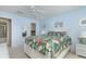 Bedroom with a queen bed, tropical bedding, and water views at 9011 Midnight Pass Rd # 228, Sarasota, FL 34242