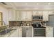 Updated kitchen featuring granite countertops and stainless steel appliances at 9011 Midnight Pass Rd # 228, Sarasota, FL 34242
