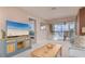 Bright living room with water views, comfy seating, and a large TV at 9011 Midnight Pass Rd # 228, Sarasota, FL 34242