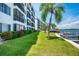 Waterfront condo building exterior showing a unit with a balcony at 9011 Midnight Pass Rd # 228, Sarasota, FL 34242