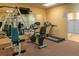 Community gym with stationary bikes, treadmills, and strength training equipment at 9011 Midnight Pass Rd # 228, Sarasota, FL 34242