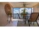 Relaxing screened-in balcony overlooking the water with outdoor seating at 9011 Midnight Pass Rd # 228, Sarasota, FL 34242