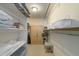 Spacious walk-in closet with ample shelving and a wardrobe at 9011 Midnight Pass Rd # 228, Sarasota, FL 34242