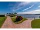 Brick pathway leading to waterfront with gazebo and lush landscaping at 9011 Midnight Pass Rd # 228, Sarasota, FL 34242