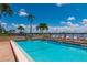 Inviting community pool with waterfront views and lounge chairs at 9011 Midnight Pass Rd # 228, Sarasota, FL 34242