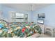 Bright bedroom with water views, featuring a comfortable bed and TV at 9011 Midnight Pass Rd # 228, Sarasota, FL 34242