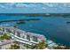 Aerial view of waterfront building with surrounding landscape at 9011 Midnight Pass Rd # 228, Sarasota, FL 34242