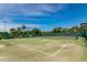 Two well-maintained tennis courts surrounded by lush landscaping at 9011 Midnight Pass Rd # 228, Sarasota, FL 34242