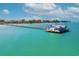 Aerial view of a pier extending into the ocean with a building at the end at 535 70Th St, Holmes Beach, FL 34217