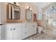 Elegant bathroom with double vanity, a large mirror, and a walk-in shower at 535 70Th St, Holmes Beach, FL 34217