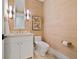 Stylish powder room with white vanity and textured wallpaper at 535 70Th St, Holmes Beach, FL 34217