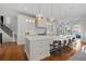 Large kitchen island with white cabinets and hardwood floors at 535 70Th St, Holmes Beach, FL 34217