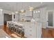 Gourmet kitchen with white cabinetry, large island, and gold accents at 535 70Th St, Holmes Beach, FL 34217