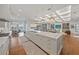 Open concept kitchen with island, white cabinets, and hardwood floors at 535 70Th St, Holmes Beach, FL 34217