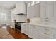 Modern kitchen with white cabinets, high-end appliances, and hardwood floors at 535 70Th St, Holmes Beach, FL 34217