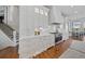 White kitchen with stainless steel appliances and hardwood floors at 535 70Th St, Holmes Beach, FL 34217