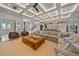 Open living area features a coffered ceiling, large sectional sofa and hardwood floors at 535 70Th St, Holmes Beach, FL 34217