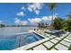 Stunning pool and spa with water views and lounge chairs at 535 70Th St, Holmes Beach, FL 34217