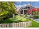 Landscaped putting green with home and lush tropical landscape at 535 70Th St, Holmes Beach, FL 34217