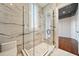 Large walk-in shower with marble tile and glass enclosure at 535 70Th St, Holmes Beach, FL 34217