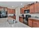 Kitchen features granite countertops, stainless steel sink and wood cabinets at 17009 Peaceful Valley Dr, Wimauma, FL 33598