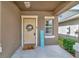 Beige front door with wreath and welcome mat at 17009 Peaceful Valley Dr, Wimauma, FL 33598