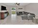 Gathering room with gray sectional and sliding glass doors at 17009 Peaceful Valley Dr, Wimauma, FL 33598