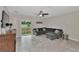 Gathering room with gray sectional sofa and sliding glass doors at 17009 Peaceful Valley Dr, Wimauma, FL 33598