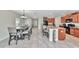 Open concept kitchen and dining area with large table and chairs at 17009 Peaceful Valley Dr, Wimauma, FL 33598