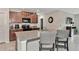 Kitchen with granite island, stainless steel appliances, and wood cabinets at 17009 Peaceful Valley Dr, Wimauma, FL 33598