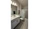 Clean bathroom featuring a white vanity, floral shower curtain, and neutral colors at 1590 Royal Rd, Venice, FL 34293