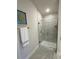 Modern bathroom featuring a tiled shower, glass door, and stylish fixtures at 1590 Royal Rd, Venice, FL 34293