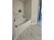Soaking tub in a well-lit bathroom with decorative touches at 1590 Royal Rd, Venice, FL 34293