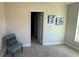 Inviting bedroom with soft carpet, soothing paint, and comfortable chair at 1590 Royal Rd, Venice, FL 34293